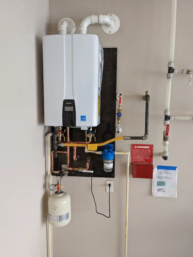 Professional plumber installing copper piping in a Dudley home